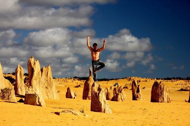 Tree pose on a limestone pillar in the Pinnacles desert, Western Australia