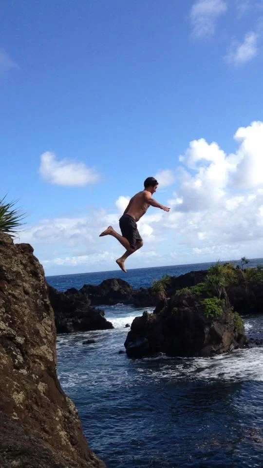 Leaping from a sea cliff into the water